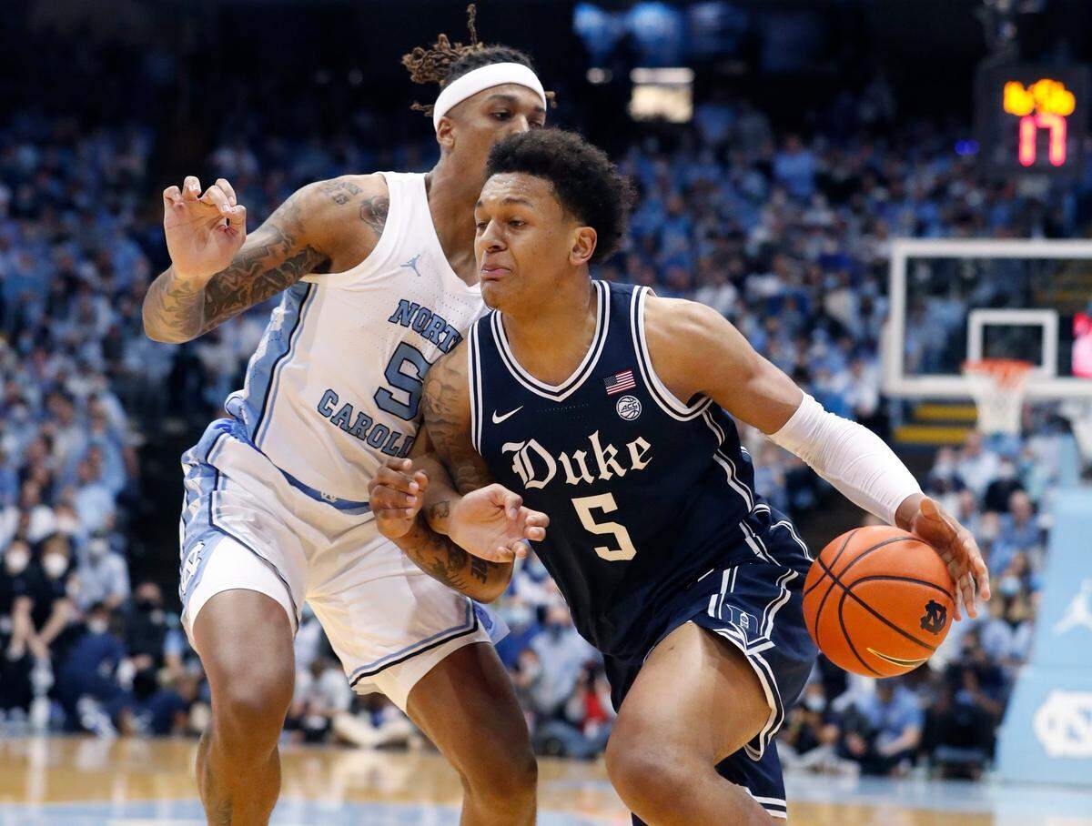 Dukes Paolo Banchero (5) drives around North Carolina’s Armando Bacot (5) during the first half of UNCs game against Duke at the Smith Center in Chapel Hill, N.C., Saturday, Feb. 5, 2022.