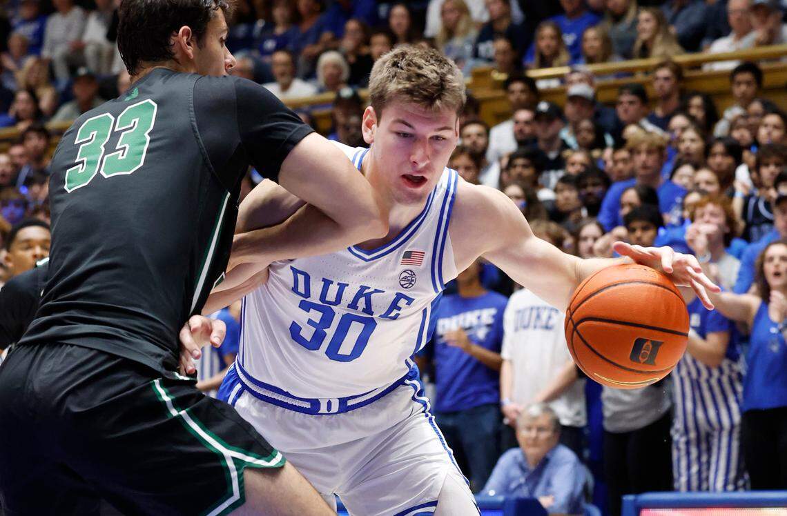 Duke’s Kyle Filipowski (30) drives around Dartmouth’s Jackson Munro (33) during the first half of Duke’s game against Dartmouth at Cameron Indoor Stadium in Durham, N.C., Monday, Nov. 6, 2023.