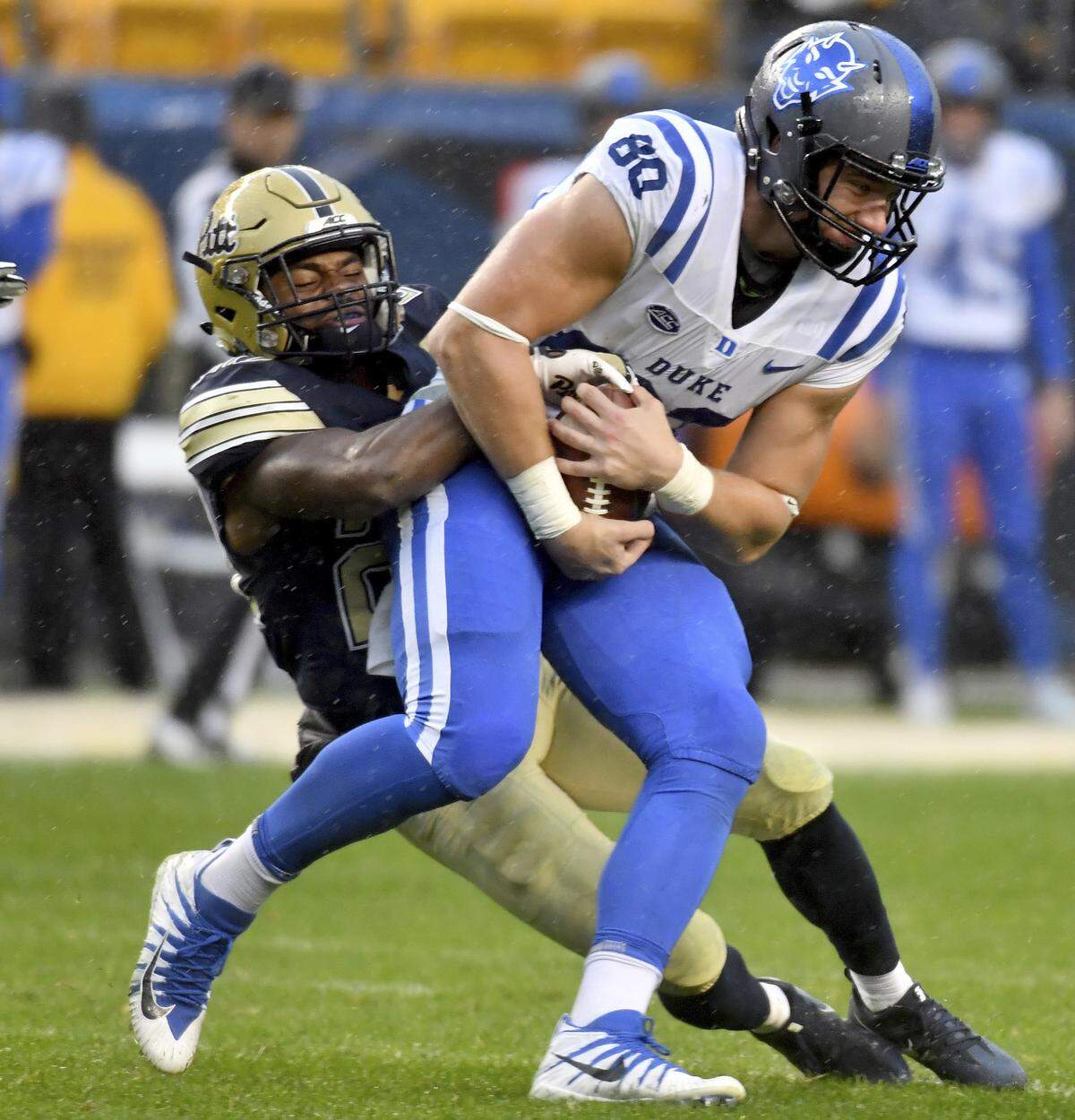 Pittsburgh defensive back Dennis Briggs takes down Duke tight end Daniel Helm in the third quarter of an NCAA college football game Saturday, Oct. 27, 2018, in Pittsburgh. 