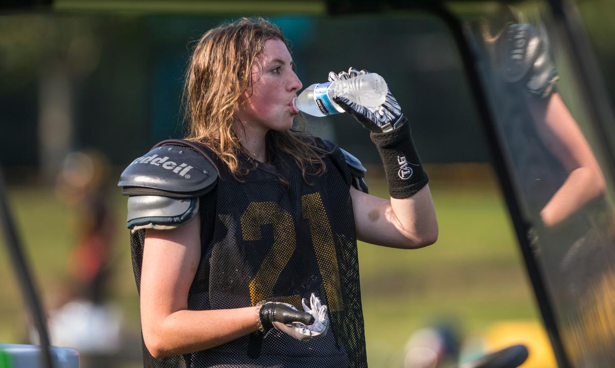 Varsity football player Brooklyn Harker takes a break to drink water during Chapel Hill High School’s football practice in Chapel Hill, N.C. on Tuesday, Sept. 14, 2021.