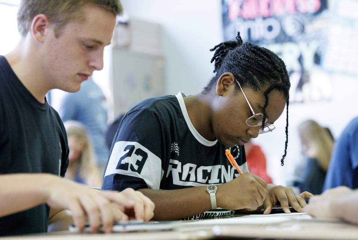 Millbrook High School sophomore Krysten Day, right, works on an assignment during a math class on Tuesday, Sept. 2, 2025, in Raleigh, N.C.
