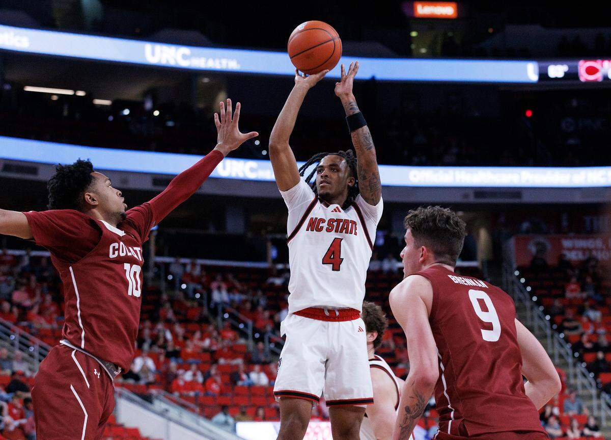 N.C. State’s Breon Pass shoots over Colgate’s Chandler Baker during the second half of the Wolfpack’s 72-49 win at Lenovo Center on Monday, Nov. 18, 2024, in Raleigh, N.C.