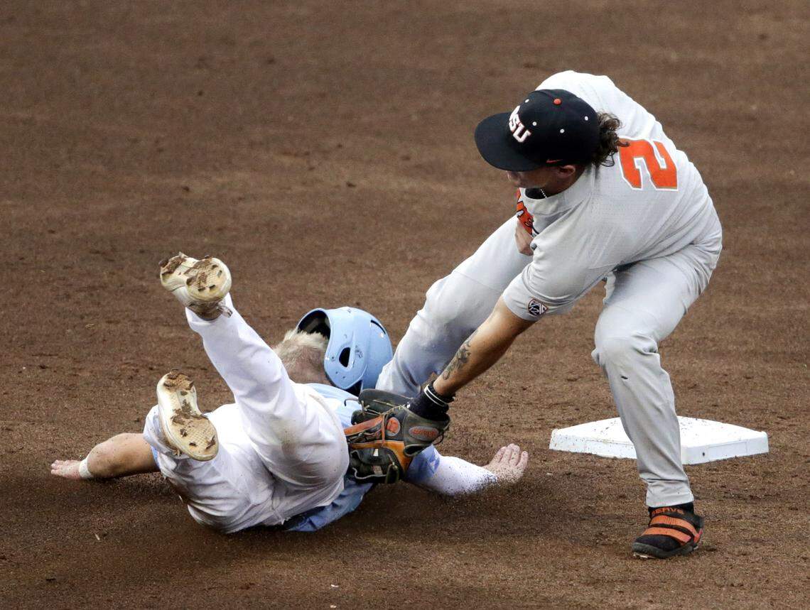 North Carolina's Ike Freeman is caught stealing second base by Oregon State shortstop Cadyn Grenier (2) during the second inning of an NCAA College World Series baseball elimination game in Omaha, Neb., Wednesday, June 20, 2018.