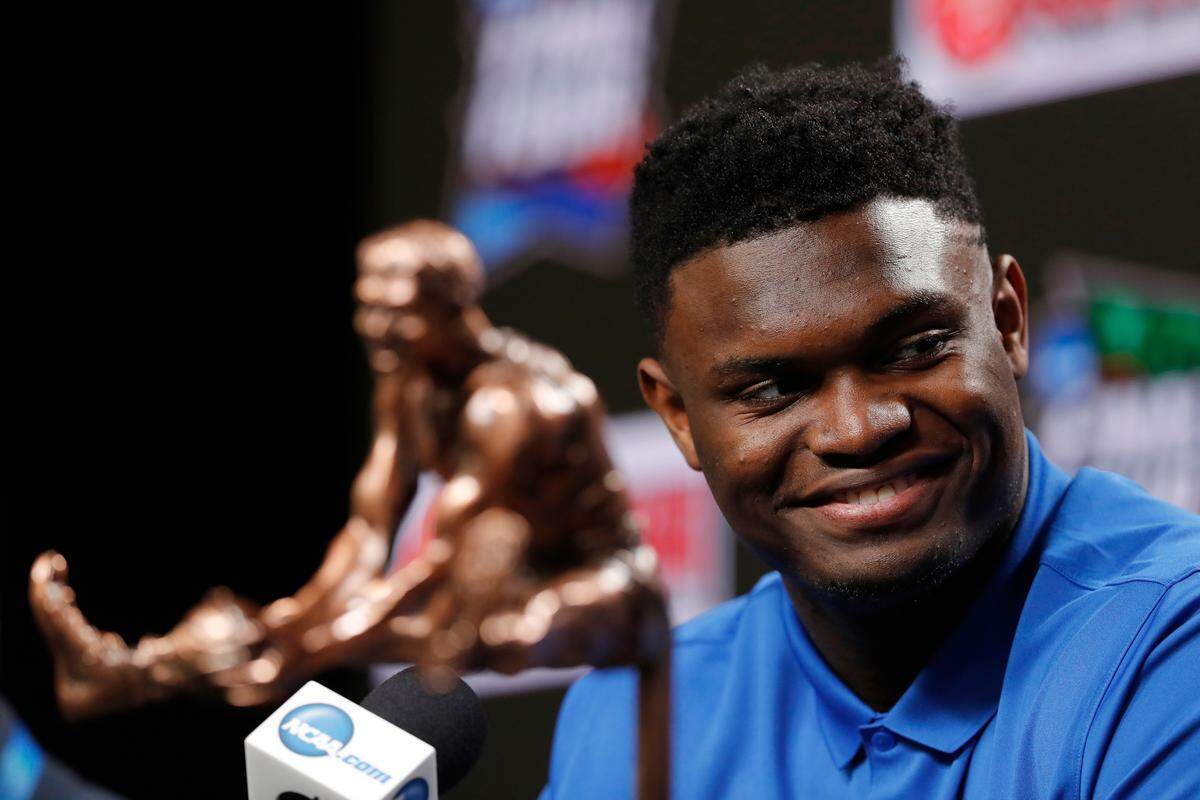 Duke freshman Zion Williamson sits behind the Oscar Robertson Trophy at a news conference where he was awarded the U.S. Basketball Writers Association College Player of the Year award at the Final Four NCAA college basketball tournament, Friday, April 5, 2019, in Minneapolis. (AP Photo/Charlie Neibergall)