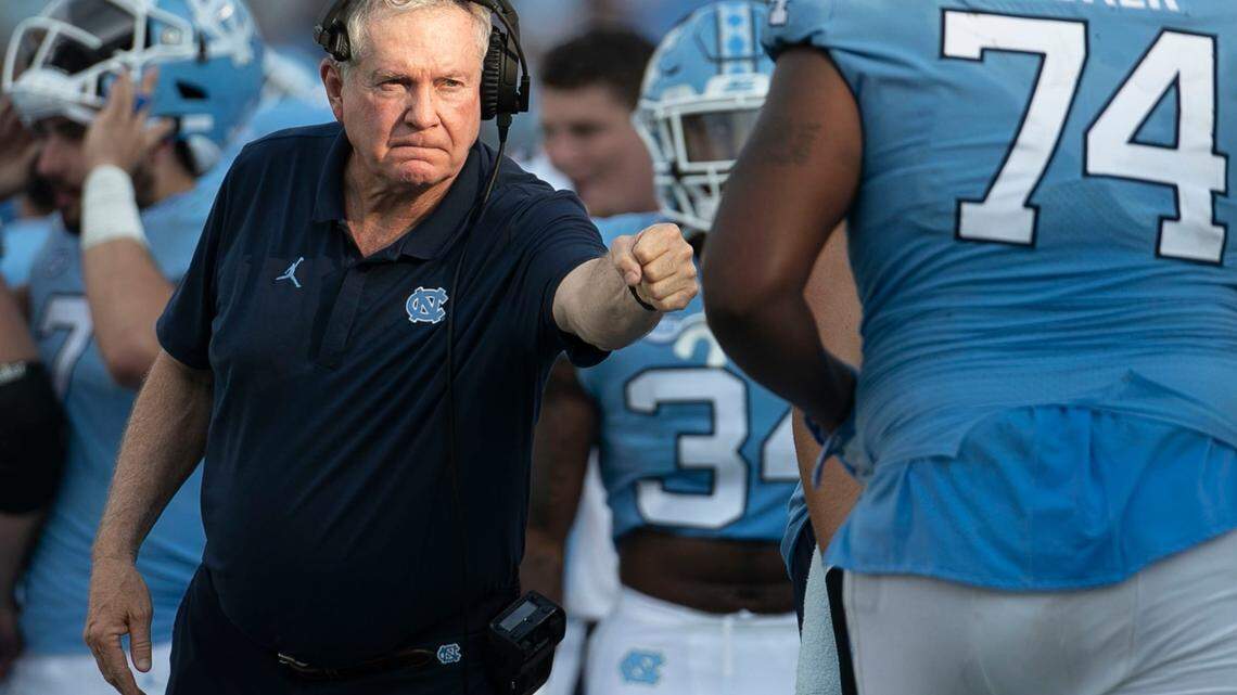 North Carolina coach Mack Brown offers a fist bump to offensive lineman Jordan Tucker (74) in the third quarter after a North Carolina touchdown on Saturday, September 21, 2019 at Kenan Stadium in Chapel Hill, N.C.