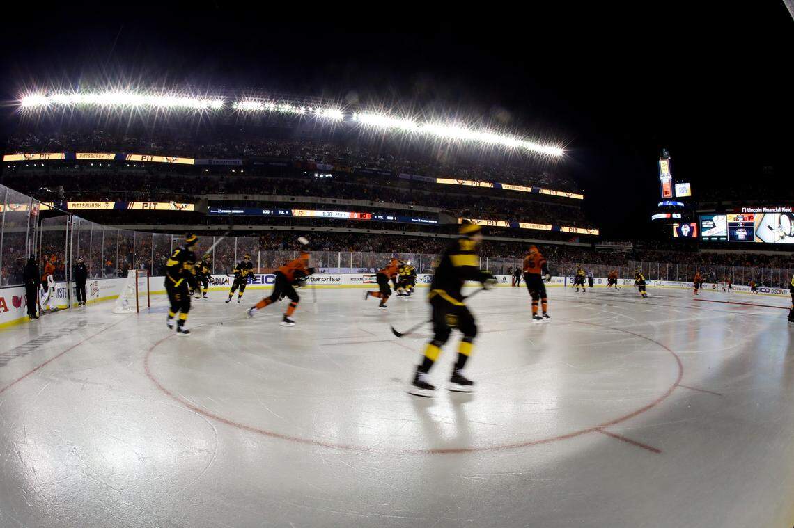 Philadelphia Flyers and Pittsburgh Penguins players warm up before an NHL Stadium Series hockey game at Lincoln Financial Field, Saturday, Feb. 23, 2019, in Philadelphia. (AP Photo/Matt Slocum)