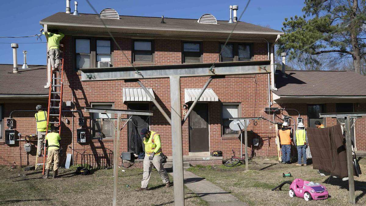 Electrical contractors from DB King work on the exterior of Building 28 on Friday, February 14, 2020 at McDougald Terrace in Durham, N.C. Eight families were notified on Friday that they could move back into their renovated units.