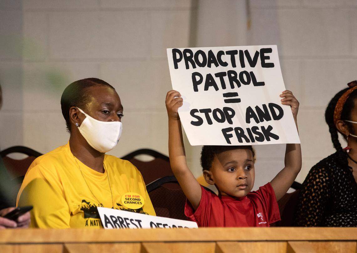 Majesty Hyman, 4, holds a sign aloft while sitting with his mother, Laticia Hyman, prior to a press conference held by attorney Ben Crump and the family of Darryl Williams on Thursday, Feb. 16, 2023, at Mount Peace Baptist Church in Raleigh, N.C. Williams died in police custody on Jan. 17.