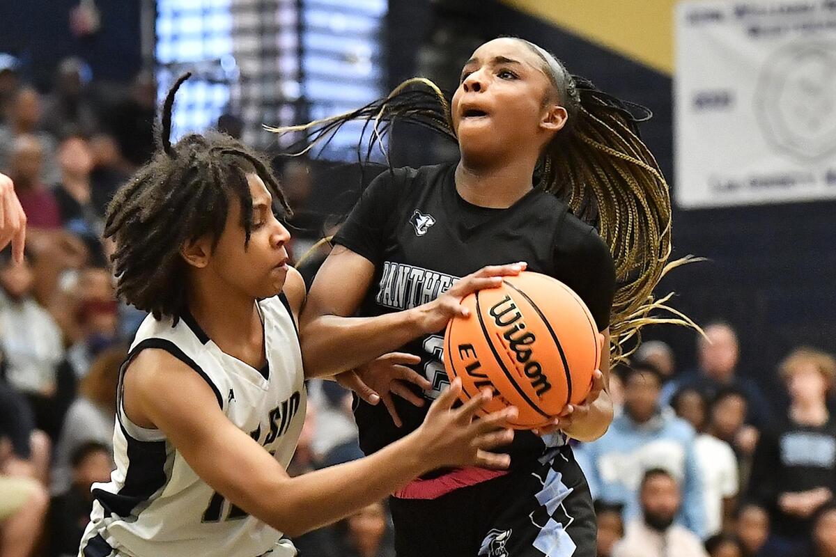 Panther Creek’s Taylor Barner (2) drives to the basjt against Hillside’s Sa’nya Horton (12) during the first half. The Hillside Hornets and the Panther Creek Catamounts met in the NCHSAA 4A East Regional Finals in Sanford, N.C. on March 4, 2023.