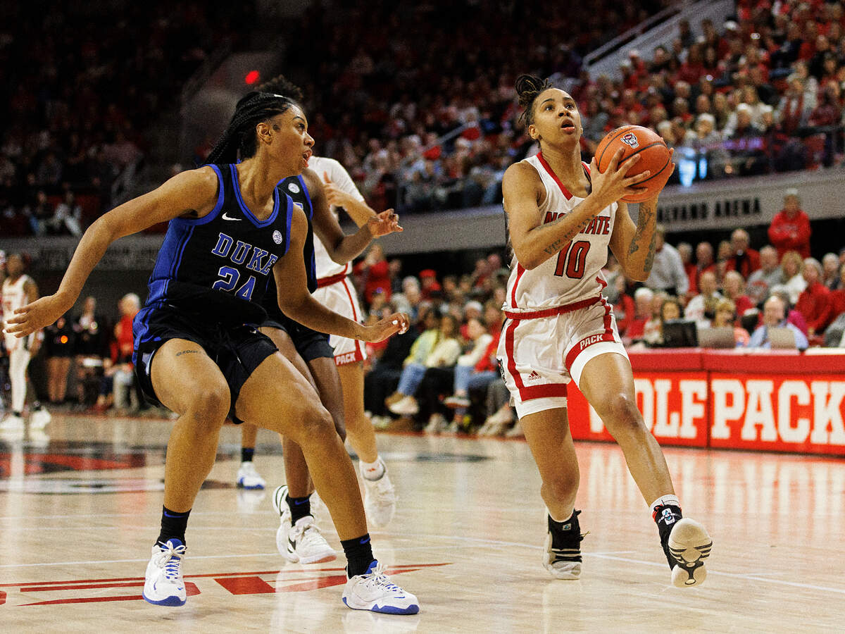 N.C. State’s Aziaha James drives to the basket past Duke’s Reigan Richardson during the second half of the Wolfpack’s 72-57 win on Sunday, Jan. 21, 2024, at Reynolds Coliseum in Raleigh, N.C.