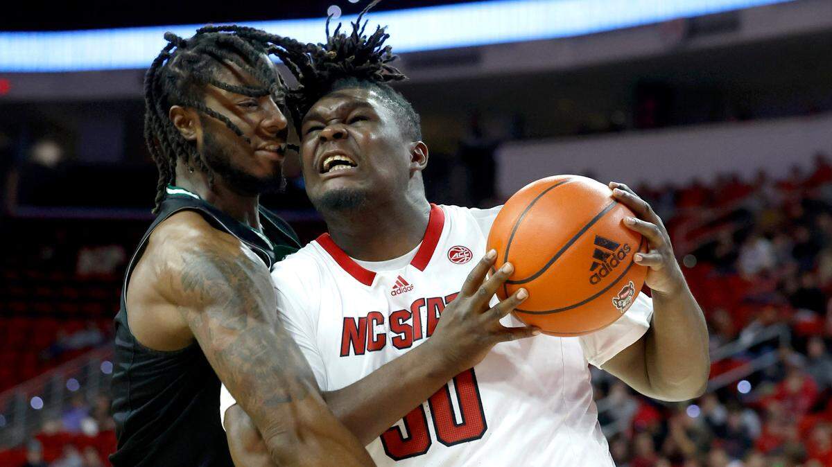 N.C. State’s DJ Burns Jr. (30) drives to the basket as Mount Olive’s Kahlif Barnes (0) defends during the second half of N.C. State’s 89-76 exhibition victory over Mount Olive at PNC Arena in Raleigh, N.C., Wednesday, Nov. 1, 2023.