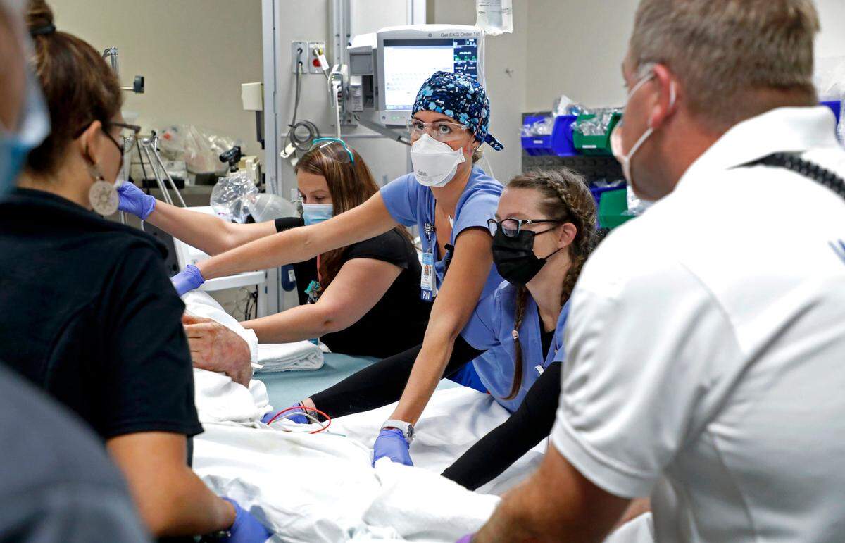 Erica Jones South, center, a nurse in the emergency department at Raleigh’s UNC Rex Healthcare, helps get ready to move a patient who arrived on Friday, Oct. 1, 2021.