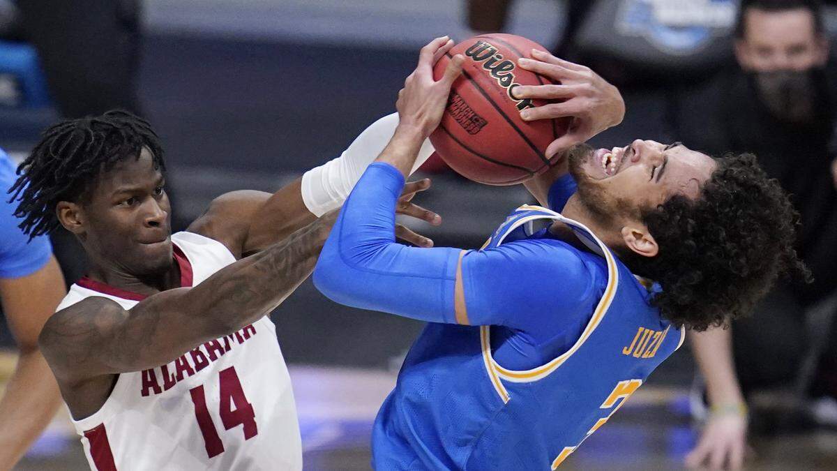 Alabama guard Keon Ellis (14) ties up UCLA guard Johnny Juzang (3) in the first half of a Sweet 16 game in the NCAA men’s college basketball tournament at Hinkle Fieldhouse in Indianapolis, Sunday, March 28, 2021. 