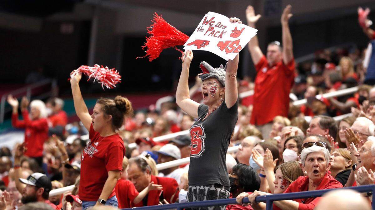 Fans cheer on the Wolfpack during the second half of N.C. State’s 60-47 victory over Miami to win the ACC women’s basketball tournament in Greensboro, N.C., Sunday, March 6, 2022.