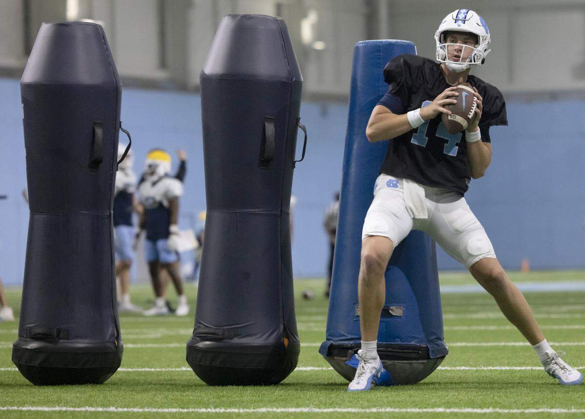 North Carolina graduate transfer quarterback Max Johnson (14) runs through a drill during the Tar Heels’ practice on Thursday, April 11, 2024 in Chapel Hill, N.C.