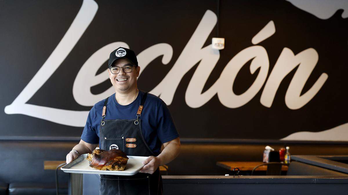 Jorge Thorne, owner of Lechon Latin BBQ in Raleigh, N.C., poses with shoulder of Lechon con cuero (roasted pork with crisp skin) Wednesday, August 27, 2025.