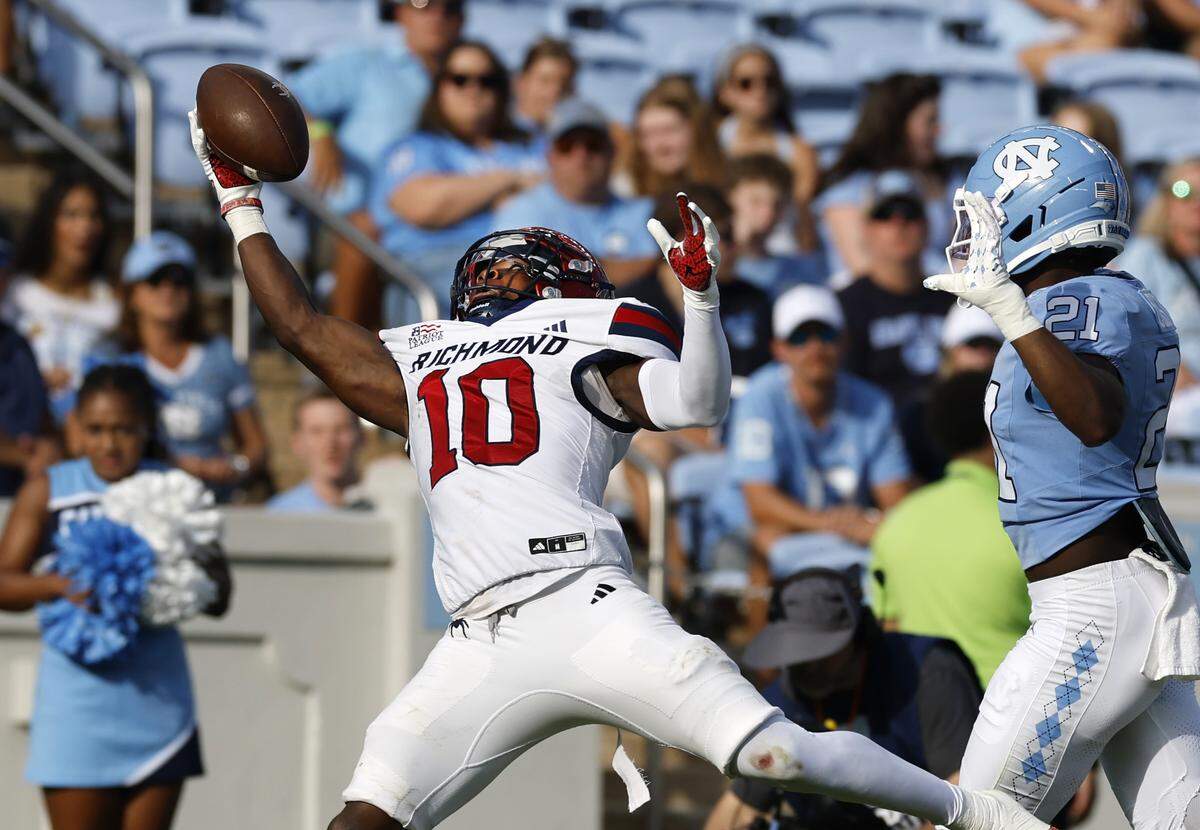 Richmond wide receiver Isaiah Dawson (10) makes a one-hand catch as North Carolina defensive back Kaleb Cost (21) trails during the second half of UNC’s 41-6 victory over Richmond at Kenan Stadium in Chapel Hill, N.C., Saturday, Sept. 13, 2025.
