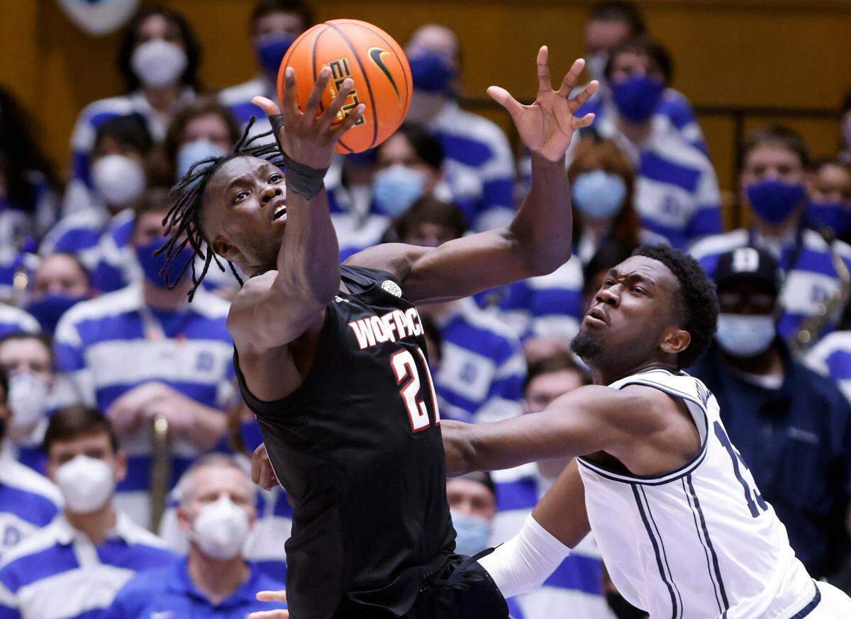 N.C. State’s Ebenezer Dowuona (21) pulls in the rebound from Duke’s Mark Williams (15) during the second half of Duke’s 88-73 victory over N.C. State at Cameron Indoor Stadium in Durham, N.C., Saturday, January 15, 2022.