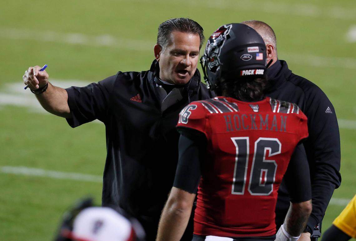 N.C. State offensive coordinator Tim Beck talks with quarterback Bailey Hockman (16) during the first half of N.C. State’s game against Florida State at Carter-Finley Stadium in Raleigh, N.C., Saturday, Nov. 14, 2020.