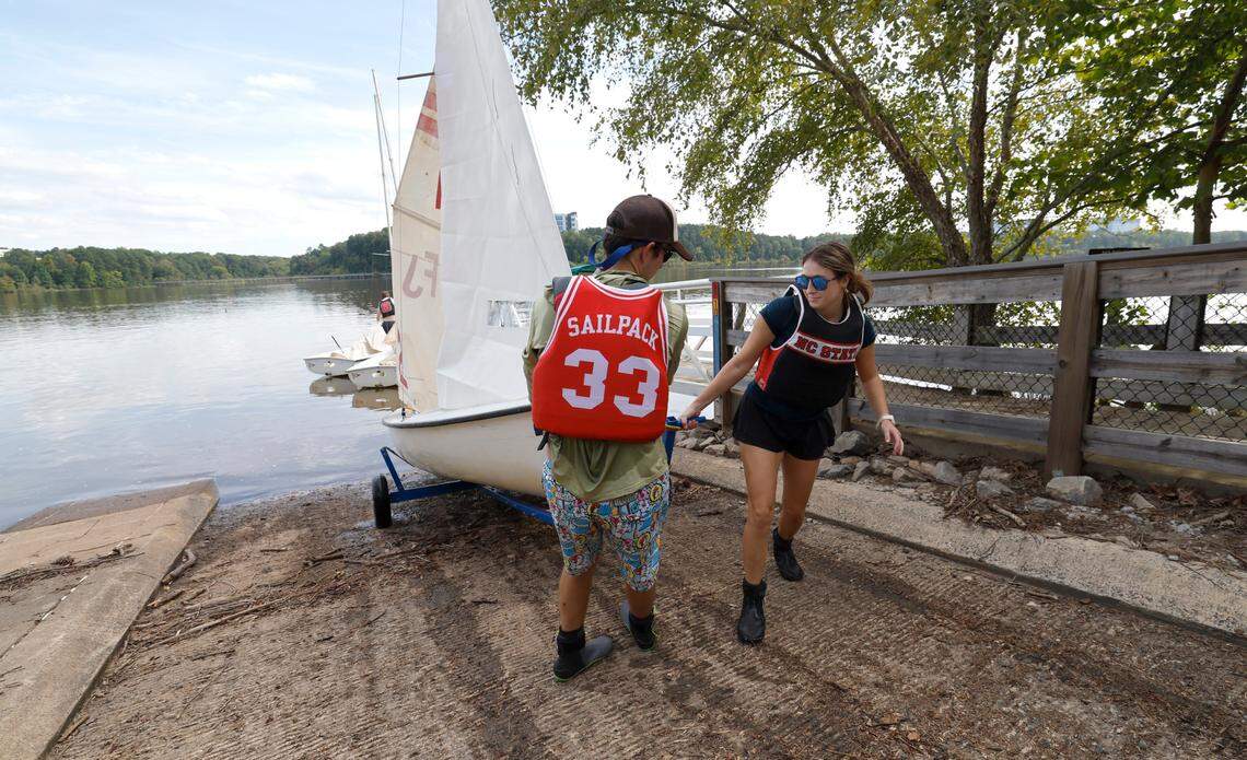 Liam Holder, left, and Shea Hoffacker pull out their boat after the N.C. State sailing team practice at Lake Crabtree in Morrisville, N.C., Friday, Sept. 6, 2024.