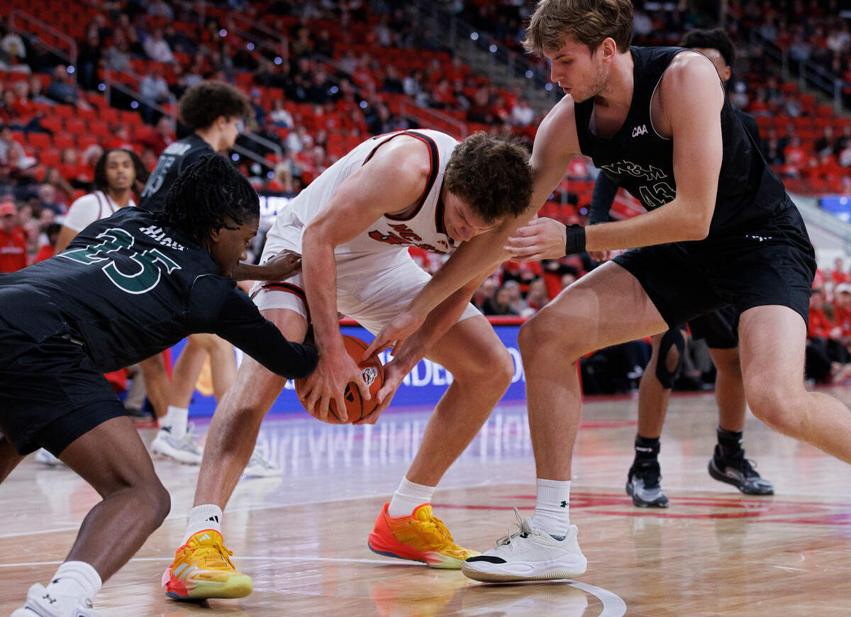 N.C. State’s Ben Middlebrooks scrambles for a loose ball with William & Mary’s Miles Hicks and Finn Lally during the second half of the Wolfpack’s 84-61 win at Lenovo Center on Friday, Nov. 22, 2024, in Raleigh, N.C.