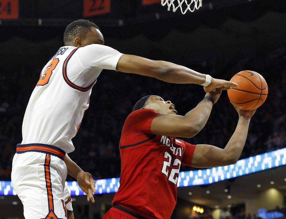 N.C. State's Ven-Allen Lubin posts up against Virginia's Ugonna Onyenso during the second half of the Wolfpack’s 90-61 loss on Thursday, Feb. 24, 2026, at John Paul Jones Arena in Charlottesville, Va. 