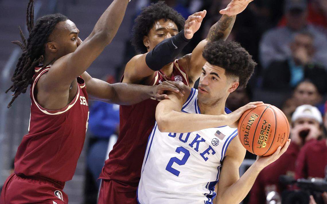 Florida State's Robert McCray V (6) and Florida State's Martin Somerville (1) pressure Duke’s Cayden Boozer (2) during the first half of Duke’s game against Florida State in the quarterfinals of the 2026 ACC Men’s Basketball Tournament at the Spectrum Center in Charlotte, N.C., Thursday, March 12, 2026.