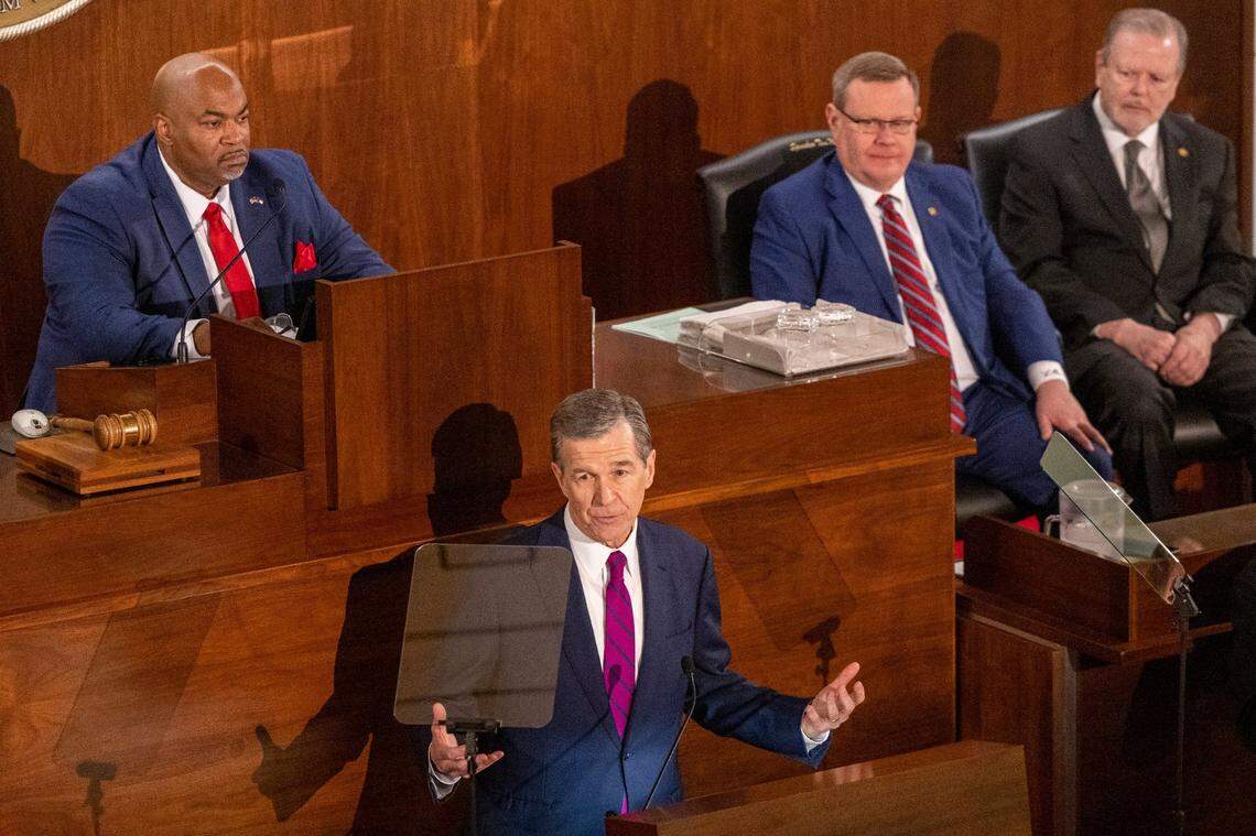 Gov. Roy Cooper delivers his State of the State address to a joint session of the N.C. General Assembly on Monday, March 6, 2023 as, from left, Lt. Gov. Mark Robinson, House Speaker Tim Moore and Senate Leader Phil Berger look on.