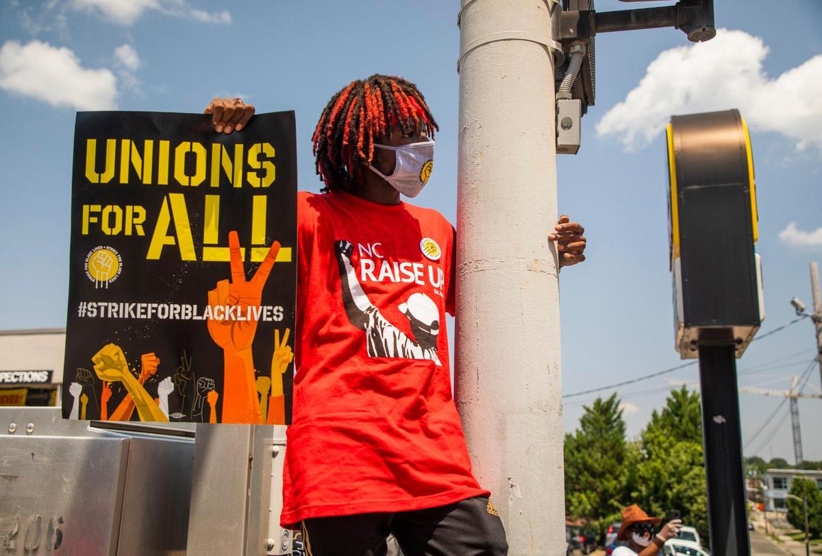 Hasan Wilson Jr., listens to organizers gathered outside McDonaldÕs during a nationwide ÔStrike for Black LivesÕ bringing together low-wage workers deemed essential during the coronavirus pandemic to demand safer working conditions and higher wages in order address poverty and police brutality in marginalized communities, on Monday, July 20, 2020, in Durham, N.C.