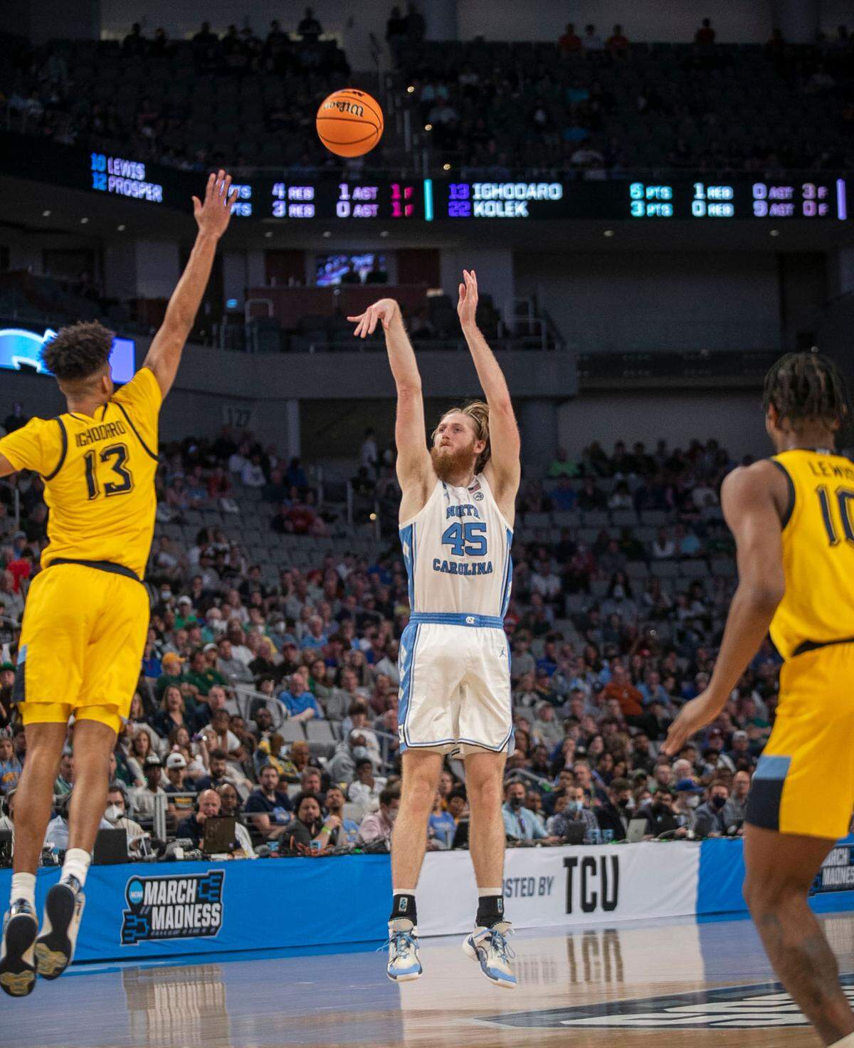 North Carolina’s Brady Manek (45) launches a three-point shot in the second half against Marquette’s Olivier-Maxence Propser (12) on Thursday, March 17, 2022 during the NCAA Tournament at Dickies Arena in Ft. Worth, TX.