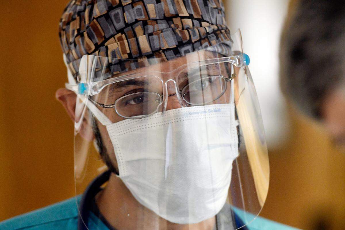 Dr. Sohail Alvi discusses how the treatment and flow of COVID patients has changed in the past year since the pandemic hit N.C. Alvi, a hospitalist, works with patients at UNC Rex Hospital Thursday, March 25, 2021.