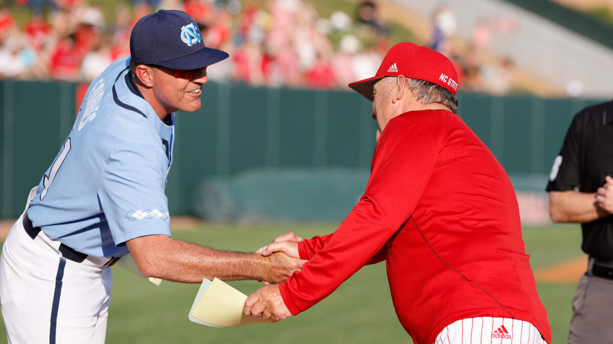 North Carolina head coach Scott Forbes and N.C. State head coach Elliott Avent shake before N.C. State’s game against UNC at Doak Field in Raleigh, N.C., Friday, May 6, 2022.