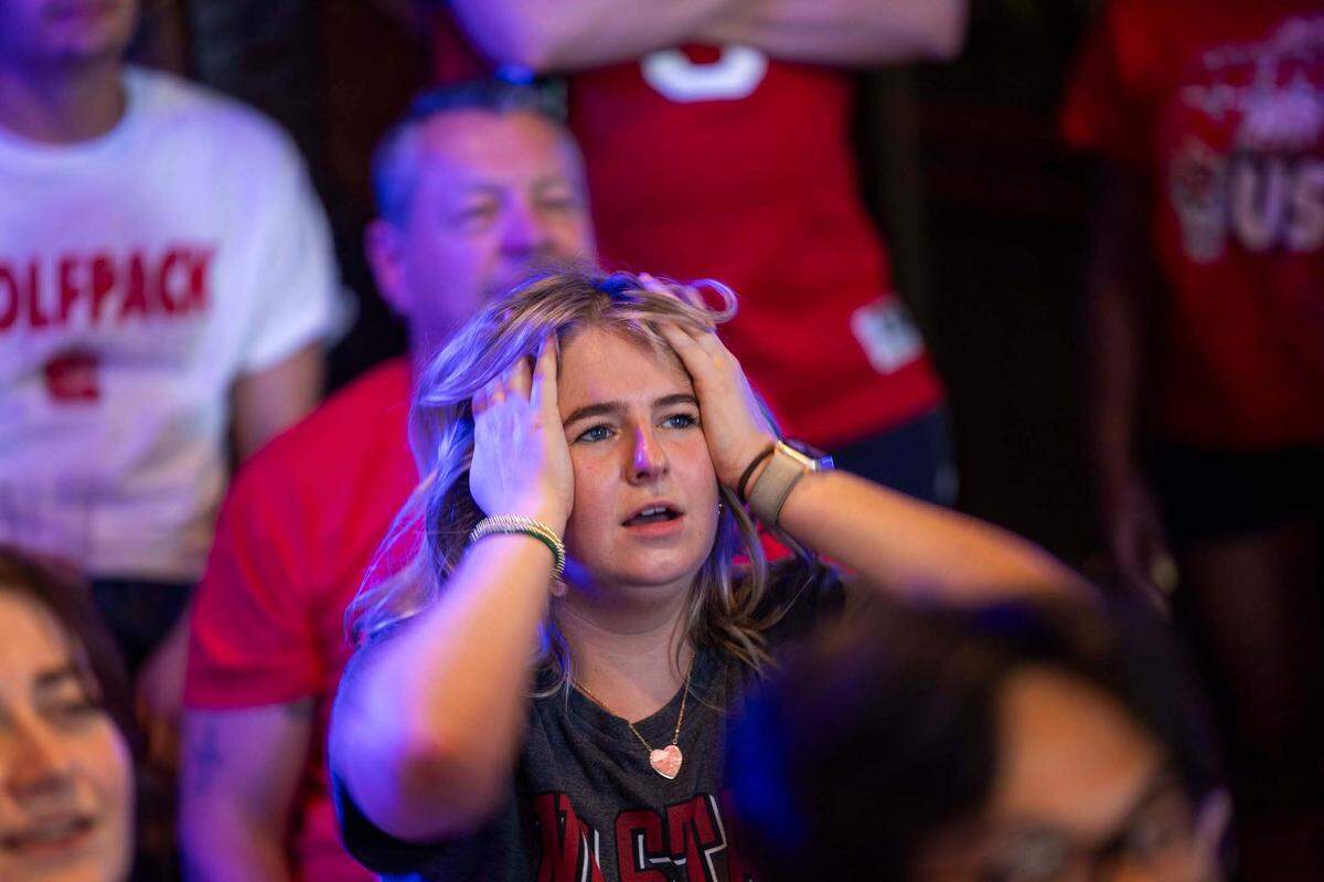 NC state fans at Players’ Retreat in Raleigh react as Duke takes an early lead against the Wolfpack lduring the first half of the Elite Eight round of the NCAA Men’s Division I Basketball Tournament on Sunday, March 31, 2024.
