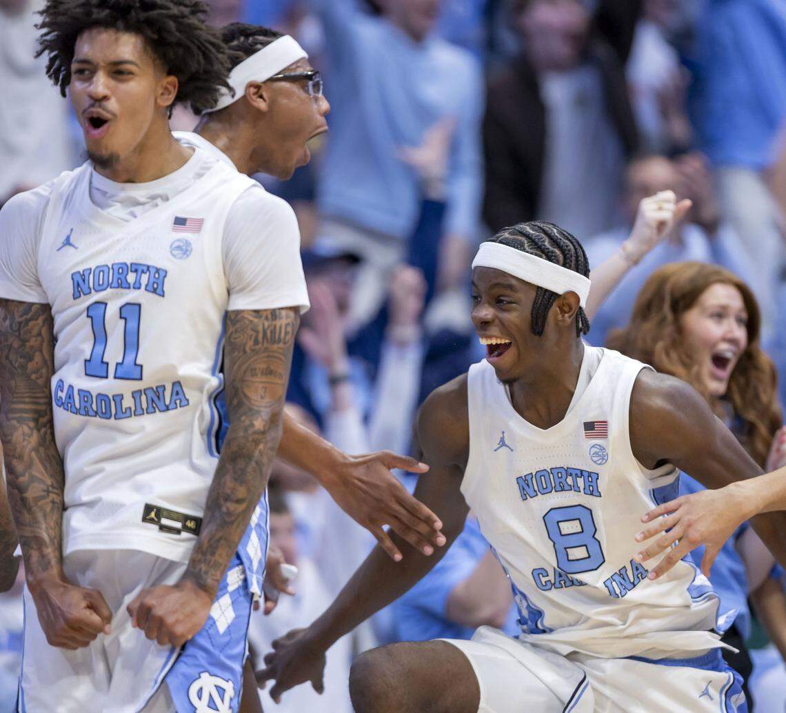 North Carolina players Jonathan Powell (11), James Brown (2) and Caleb Wilson (8), along with the Tar Heel bench, erupt in celebration after a basket by Elijah Davis (6) in the final minute of play during the Tar Heels 99-51 victory over East Carolina on Monday, December 22, 2025 in Chapel Hill, N.C.