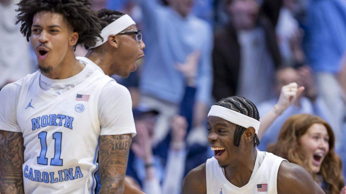 North Carolina players Jonathan Powell (11), James Brown (2) and Caleb Wilson (8), along with the Tar Heel bench, erupt in celebration after a basket by Elijah Davis (6) in the final minute of play during the Tar Heels 99-51 victory over East Carolina on Monday, December 22, 2025 in Chapel Hill, N.C.