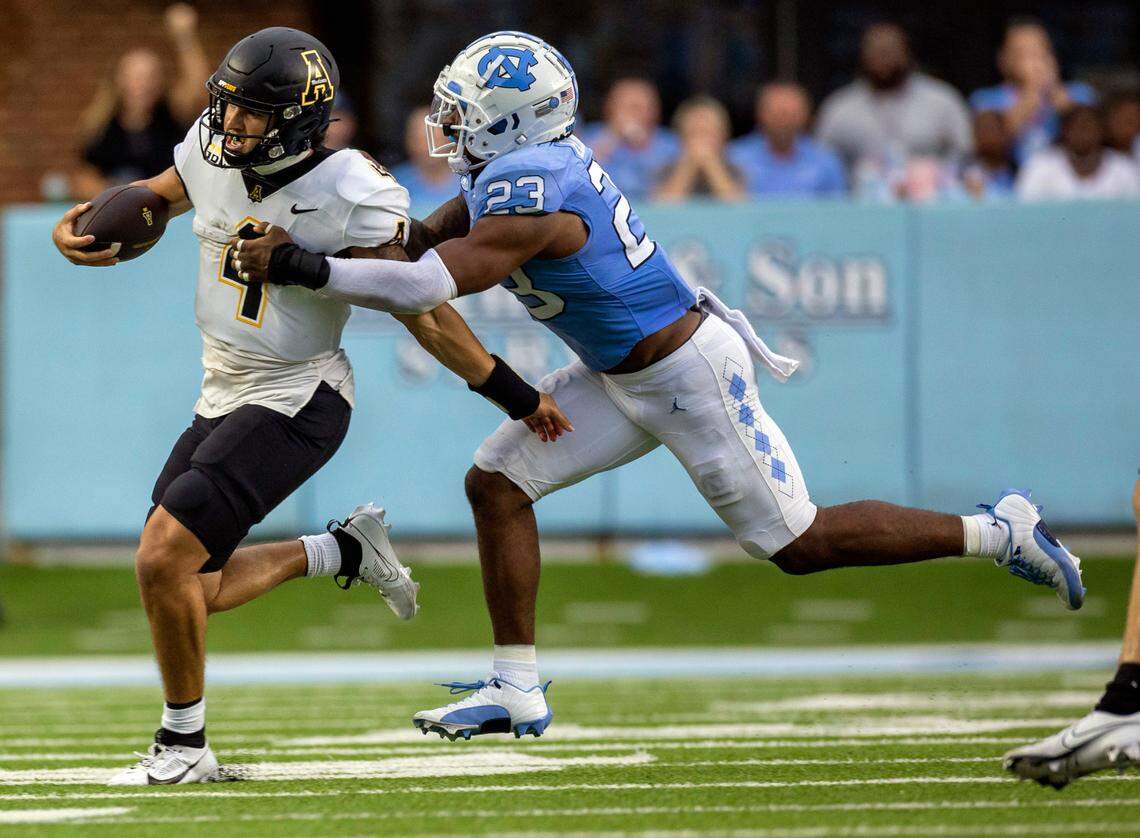 North Carolina’s Power Echols (23) stops Appalachian State quarterback Joey Aguilar (4) after a seven-yard gain in the second quarter on Saturday September 9, 2023 at Kenan Stadium in Chapel Hill, N.C.