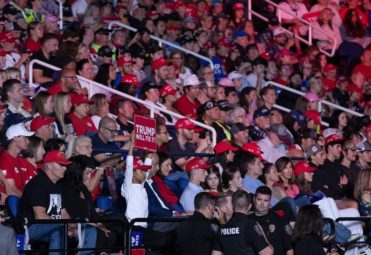 A person holds a sign aloft during remarks by former President and Republican presidential candidate Donald Trump at a campaign rally at First Horizon Coliseum in Greensboro, N.C. on Saturday, Nov. 2, 2024.
