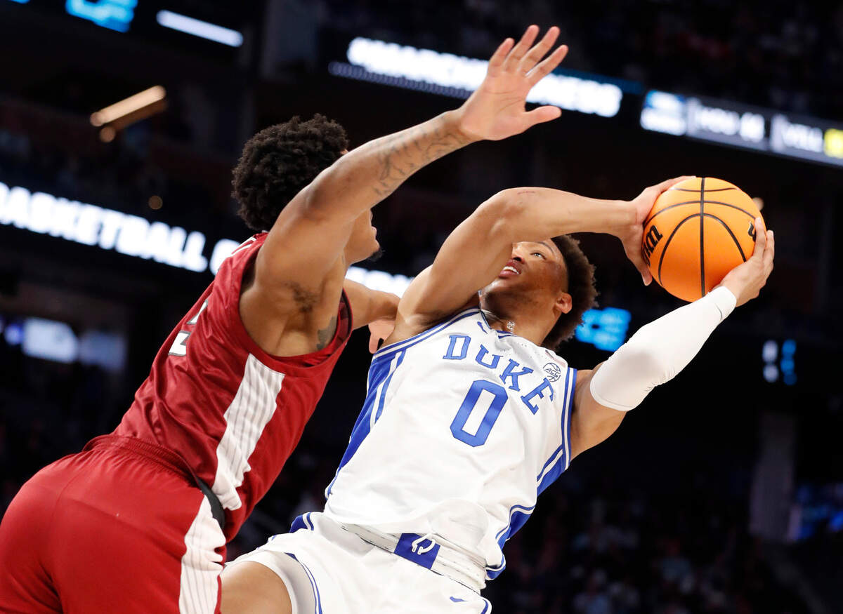 Duke’s Wendell Moore Jr. (0) shoots as Arkansas’ Au’Diese Toney (5) defends during the second half of Duke’s 78-69 victory over Arkansas in the NCAA Tournament West Regional finals at the Chase Center in San Francisco, Calif., Saturday, March 26, 2022.