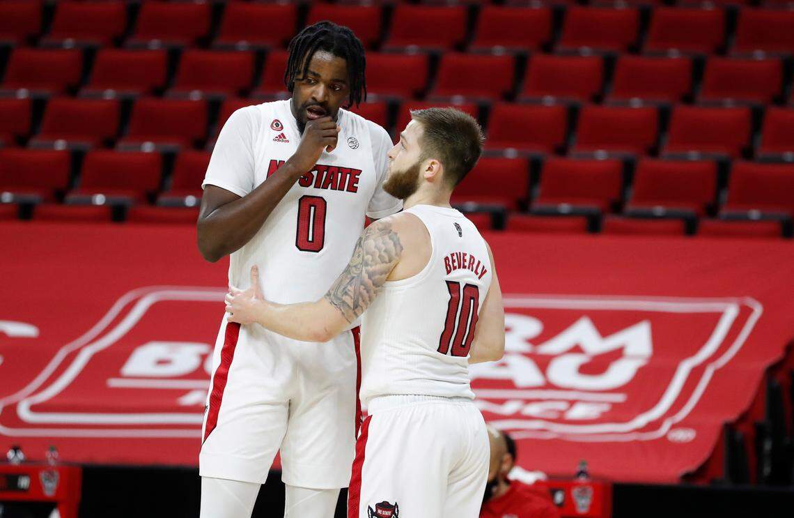 N.C. State’s D.J. Funderburk (0) talks with Braxton Beverly (10) during the second half of Miami’s 64-59 victory over N.C. State at PNC Arena in Raleigh, N.C., Saturday, January 9, 2021.