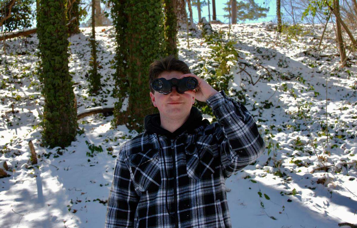 Connor Reeder birdwatches in Dix Park Sunday, Feb. 1.