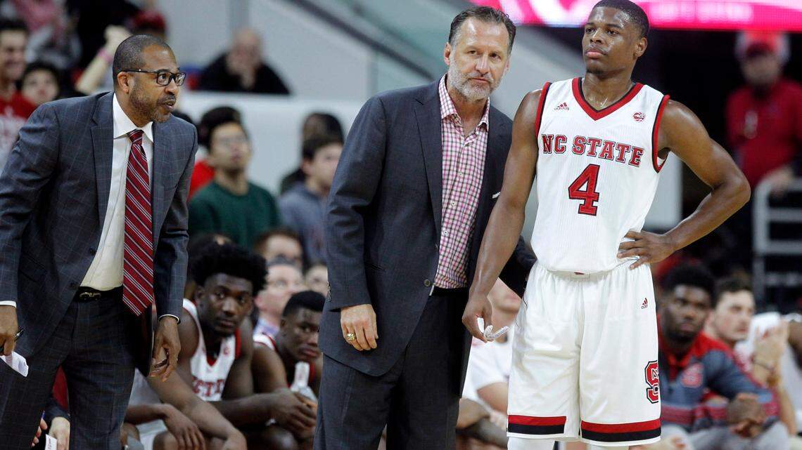 As assistant coach Orlando Early listens, N.C. State head coach Mark Gottfried talks with Dennis Smith Jr. during the Wolfpack’s game against Georgia Southern at the PNC Arena in Raleigh, N.C., Friday, Nov. 11, 2016.