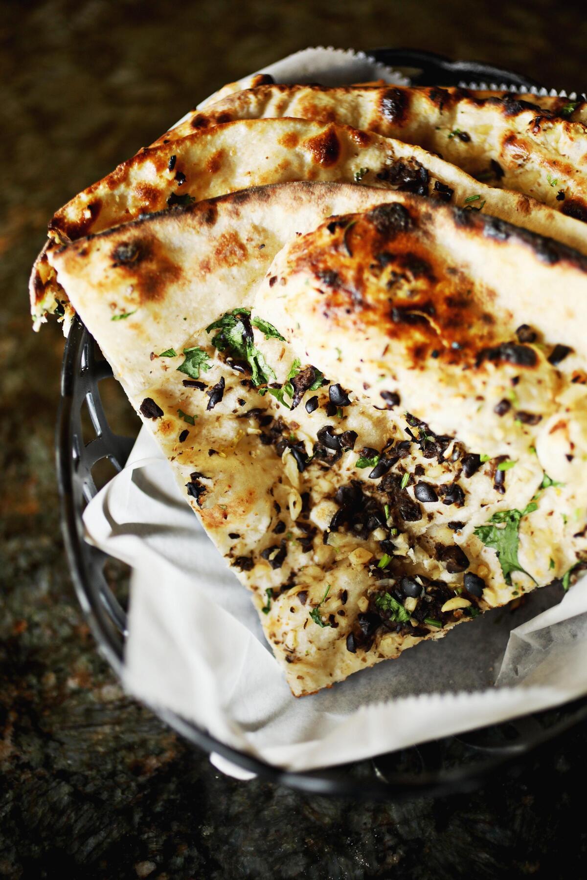 Kathmandu Kitchen’s olive garlic naan is made-to-order in the tandoor oven.