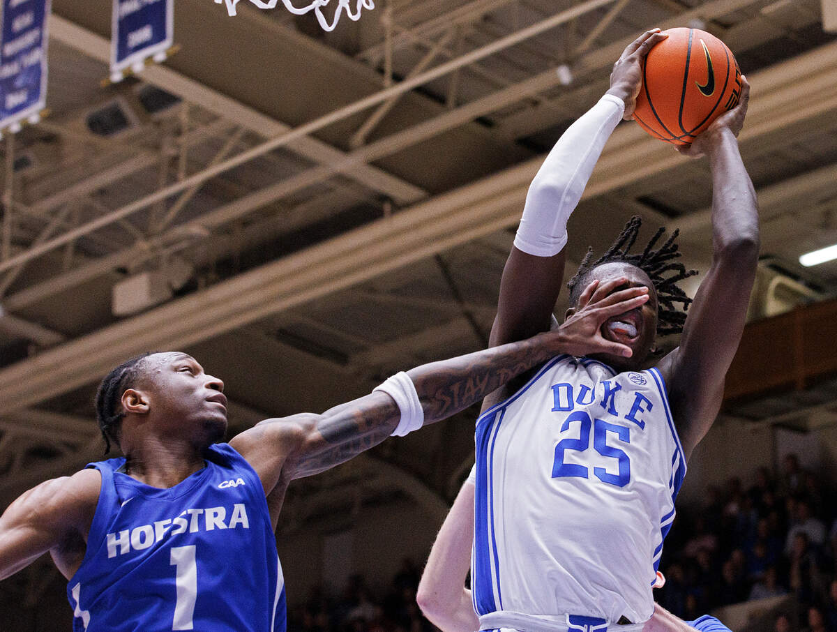 Duke’s Mark Mitchell pulls down a rebound away from Hofstra’s Darlinstone Dubar during the second half of the Blue Devils’ 89-68 win over Hofstra on Tuesday, Dec. 12, 2023, at Cameron Indoor Stadium in Durham, N.C.