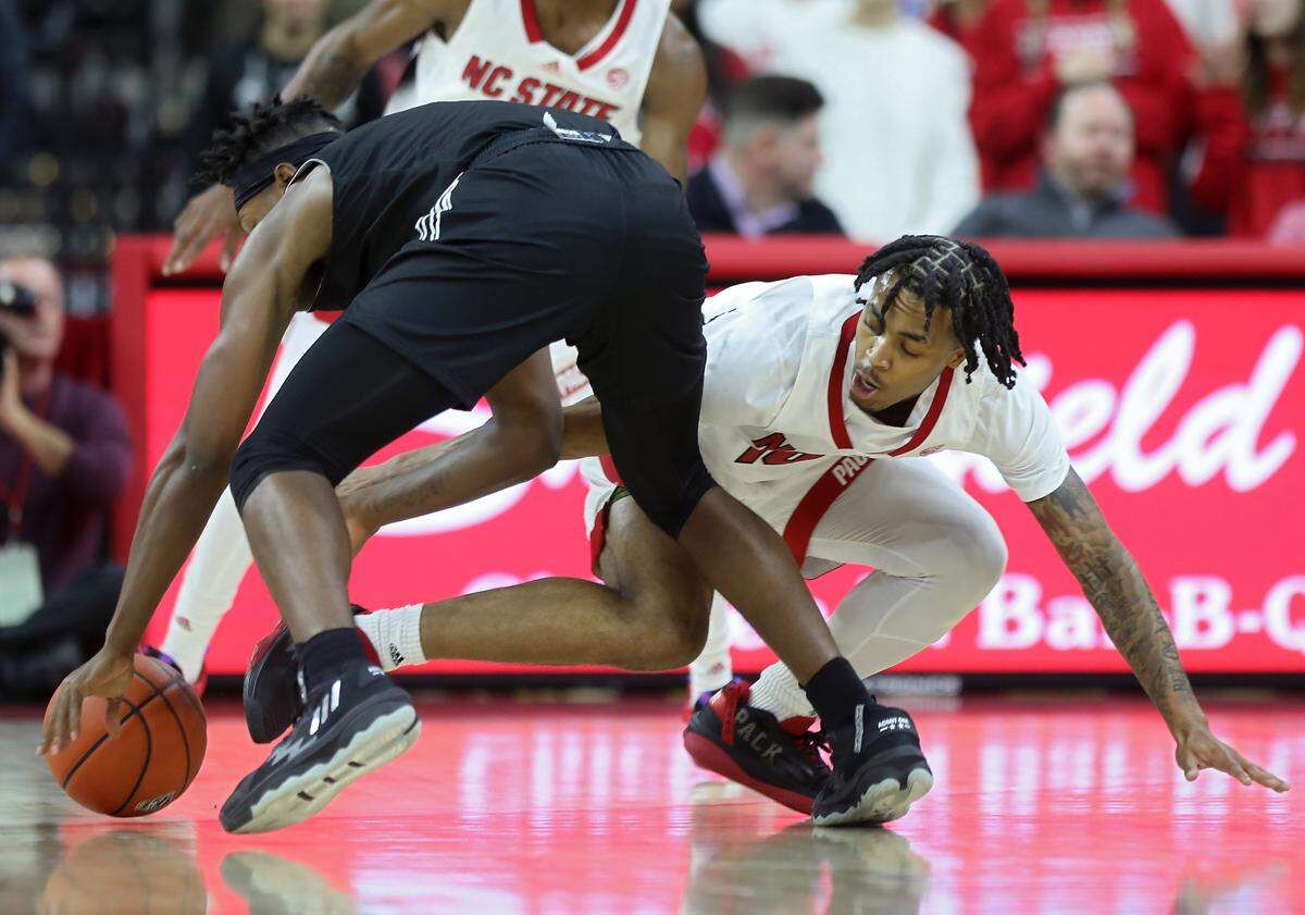 North Carolina State Wolfpack guard Breon Pass defends Florida International Golden Panthers guard Denver Jones during the first half of a men’s basketball game at PNC Arena on Tuesday, Nov. 15, 2022, in Raleigh, N.C.