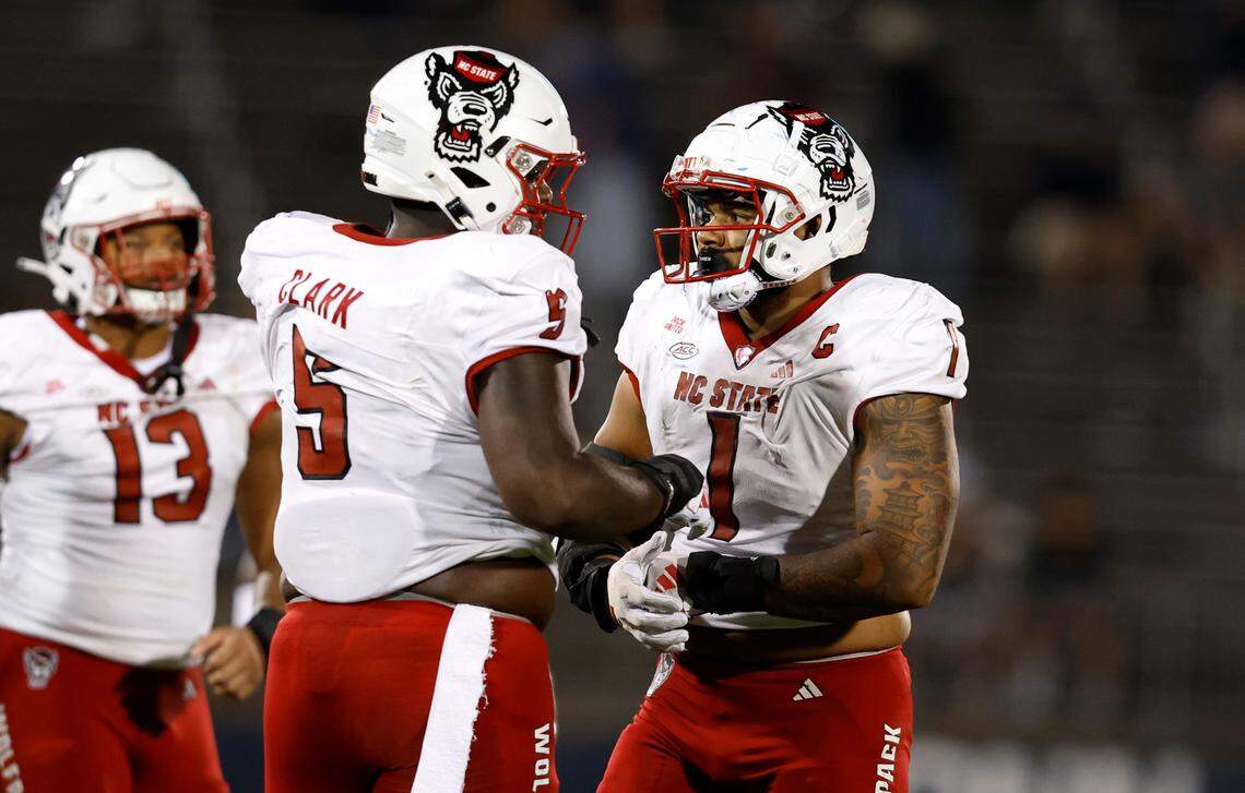 N.C. State’s C.J. Clark (5) talks with Davin Vann (1) during the second half of N.C. State’s 24-14 victory over UConn at Rentschler Field in East Hartford, Conn. Thursday, August 31, 2023.