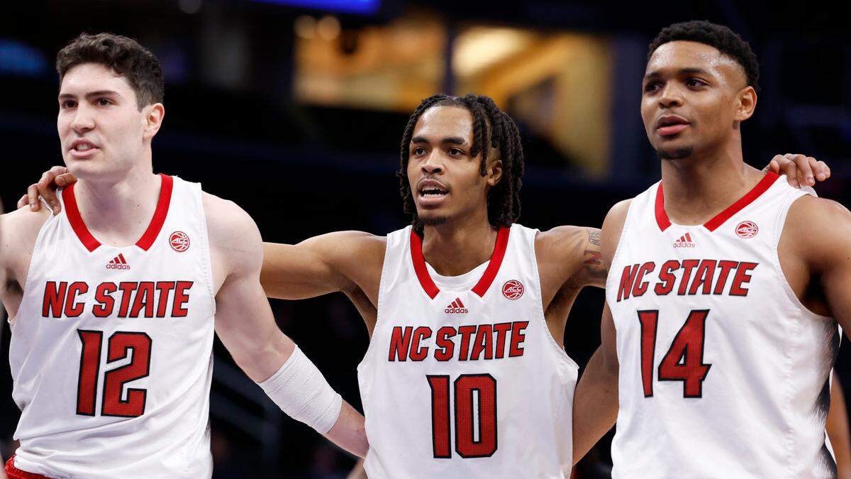 N.C. State’s Michael O’Connell (12), Breon Pass (10) and Casey Morsell (14) huddle together during the second half of N.C. State’s 94-85 victory over Louisville in the first round of the 2024 ACC Men’s Basketball Tournament at Capital One Arena in Washington, D.C., Tuesday, March 12, 2024.