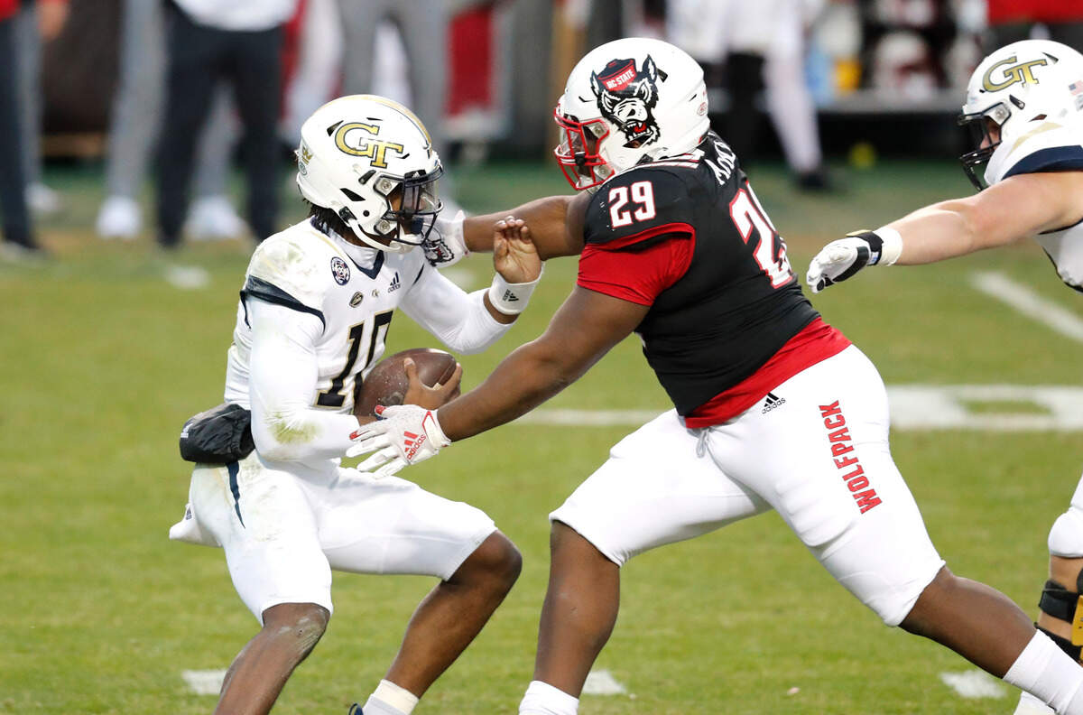 Georgia Tech quarterback Jeff Sims (10) escapes from N.C. State defensive tackle Alim McNeill (29) during the first half of N.C. State’s game against Georgia Tech at Carter-Finley Stadium in Raleigh, N.C., Saturday, Dec. 5, 2020.