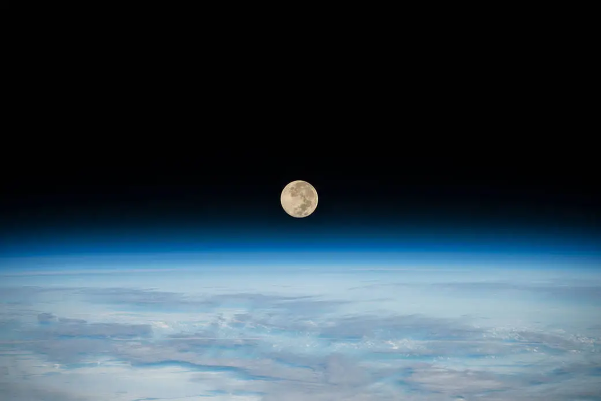 The Full Moon is pictured setting below Earth’s horizon from the International Space Station as it orbited 269 miles above the southern Indian Ocean in December 2022. The next full moon will be June 21. Some call that the Strawberry Moon.