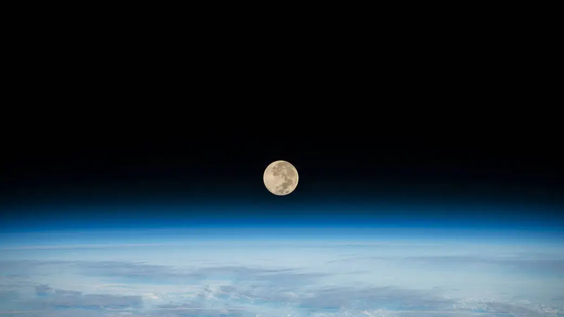 The Full Moon is pictured setting below Earth’s horizon from the International Space Station as it orbited 269 miles above the southern Indian Ocean in December 2022. The next full moon will be June 21. Some call that the Strawberry Moon.