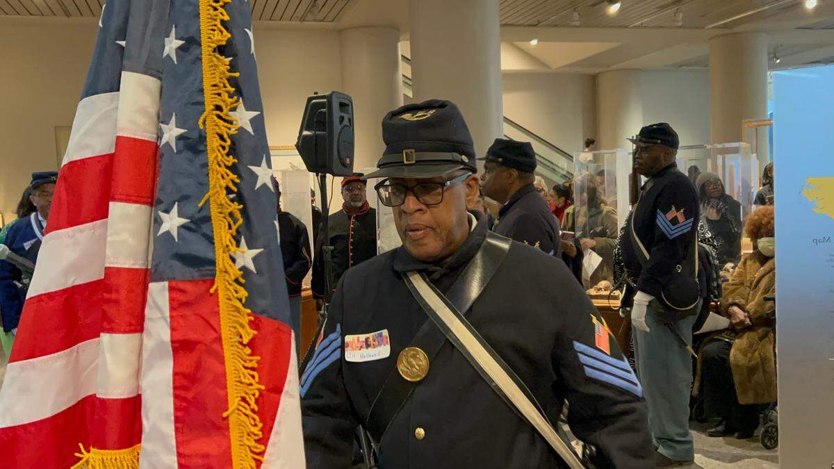 William Hollowell picks up the colors as a member of the 35th United States Colored Troops interpretive unit at the 24th Annual African American Cultural Celebration held Jan. 25, 2025 at the N.C. Museum of Natural Sciences in Raleigh. N.C.